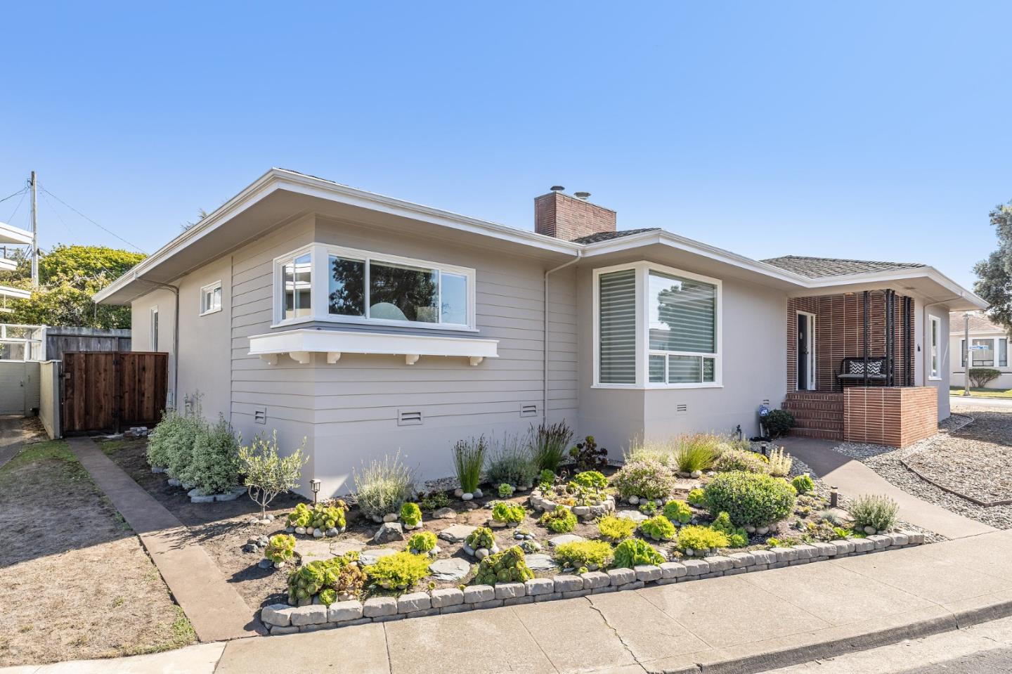 86 Cliffside Drive Daly City, CA 94015 - Photo 2 of 50 a front view of a house with a yard and potted plants