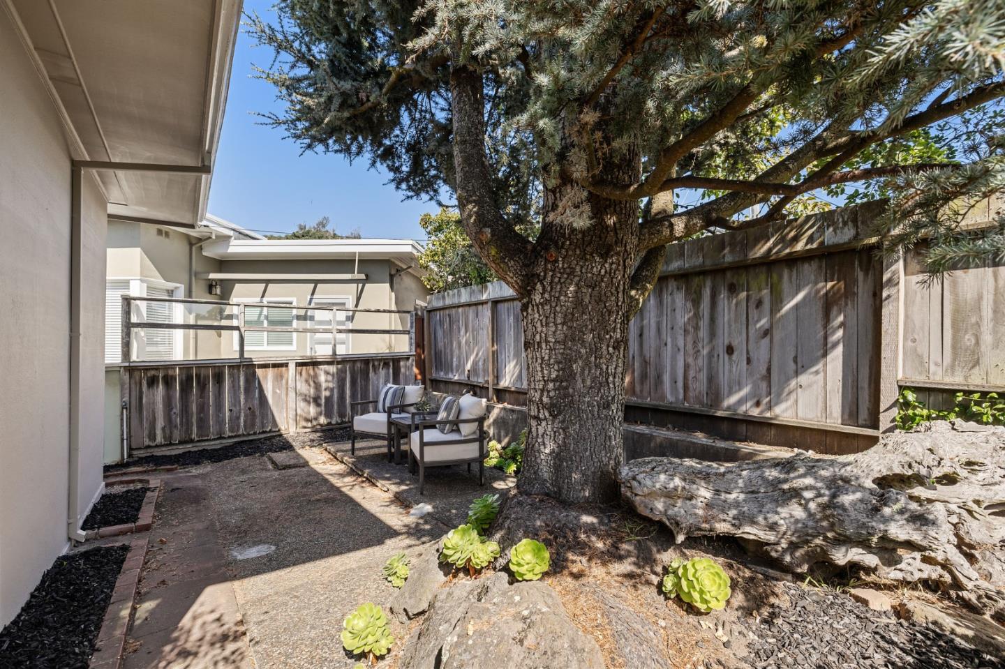 86 Cliffside Drive Daly City, CA 94015 - Photo 28 of 50 a view of a backyard with couches chair and wooden fence