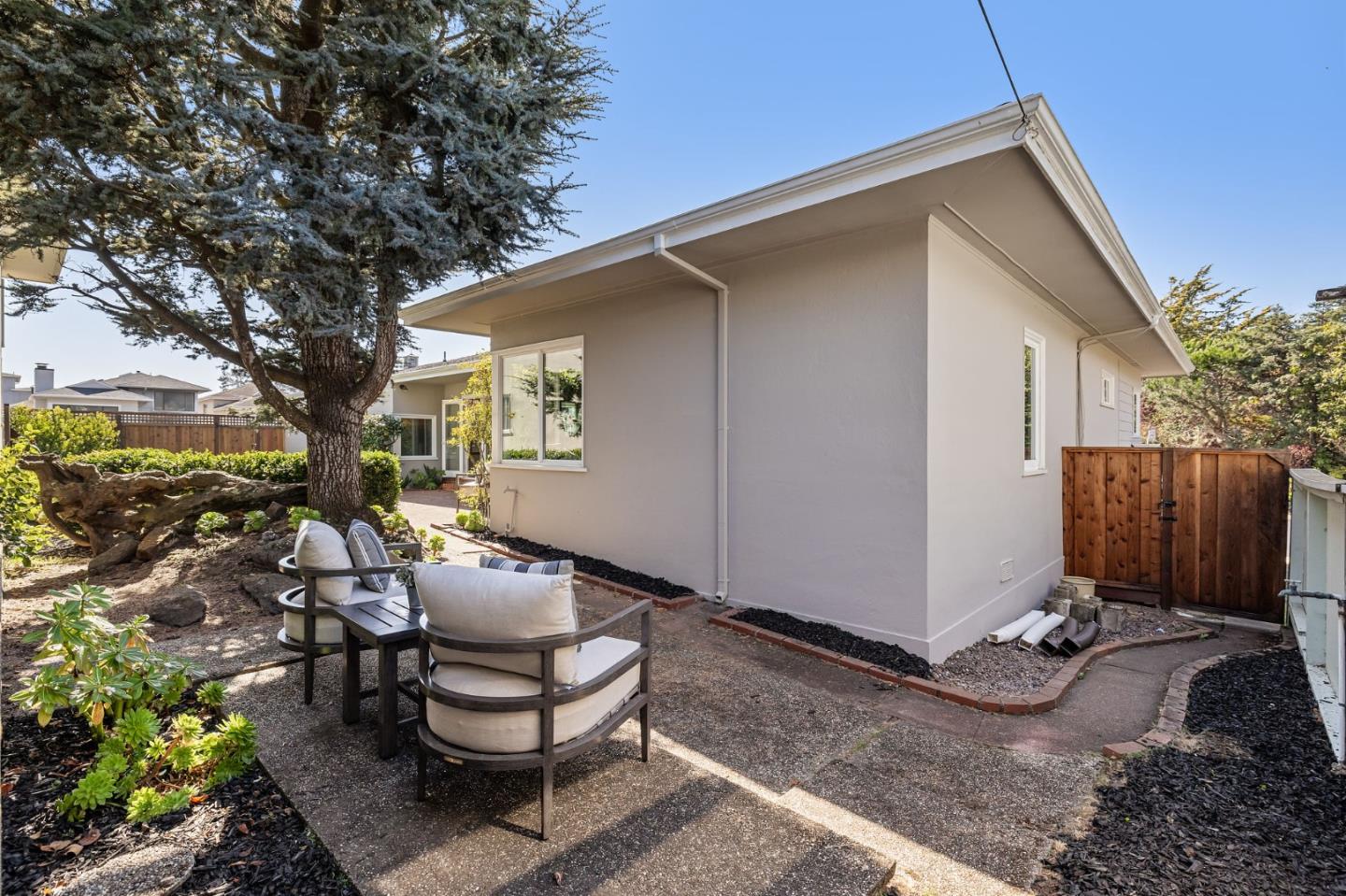 86 Cliffside Drive Daly City, CA 94015 - Photo 30 of 50 a backyard of a house with wooden fence and large trees