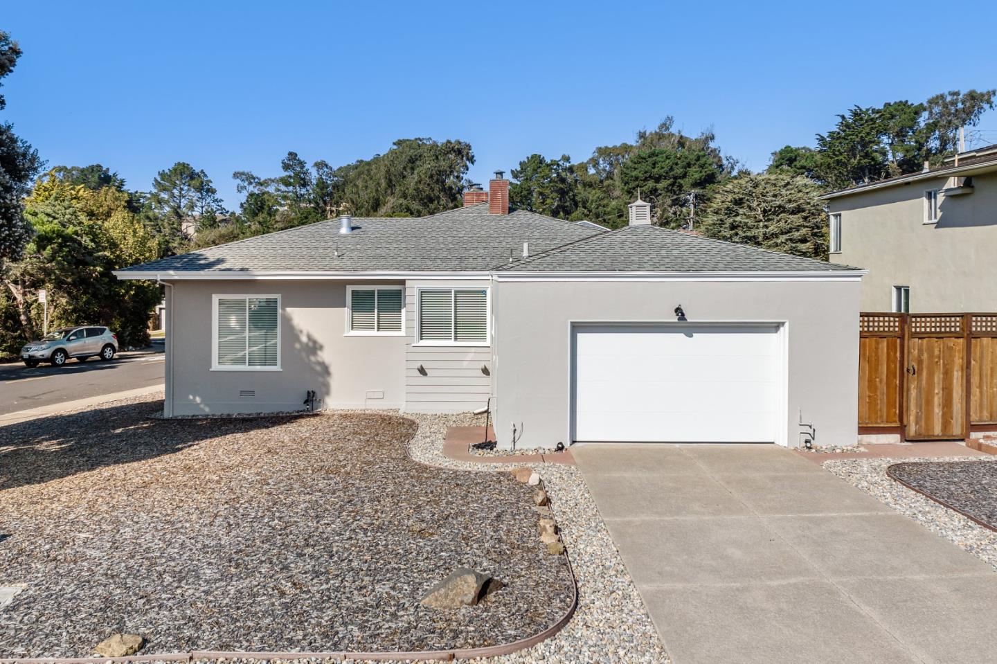 86 Cliffside Drive Daly City, CA 94015 - Photo 3 of 50 a front view of a house with a yard and garage
