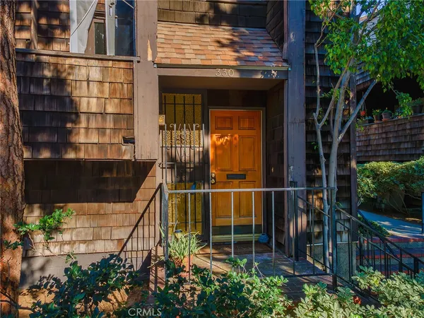 a view of a potted flower in front of a house