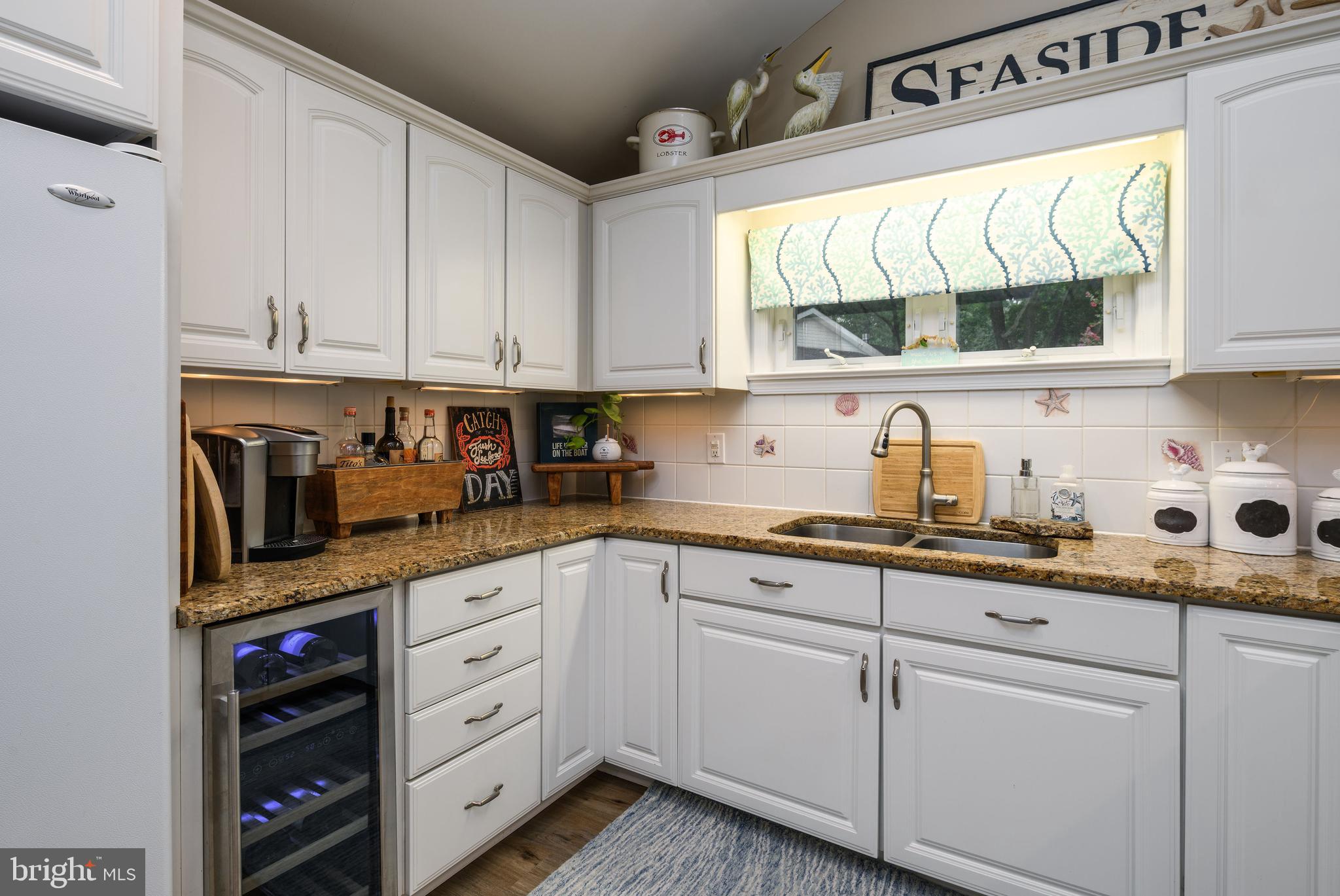 34386 Mallard Road, Unit 482 Long Neck, DE 19966 - Photo 17 of 41 a kitchen with stainless steel appliances granite countertop a sink a stove and cabinets