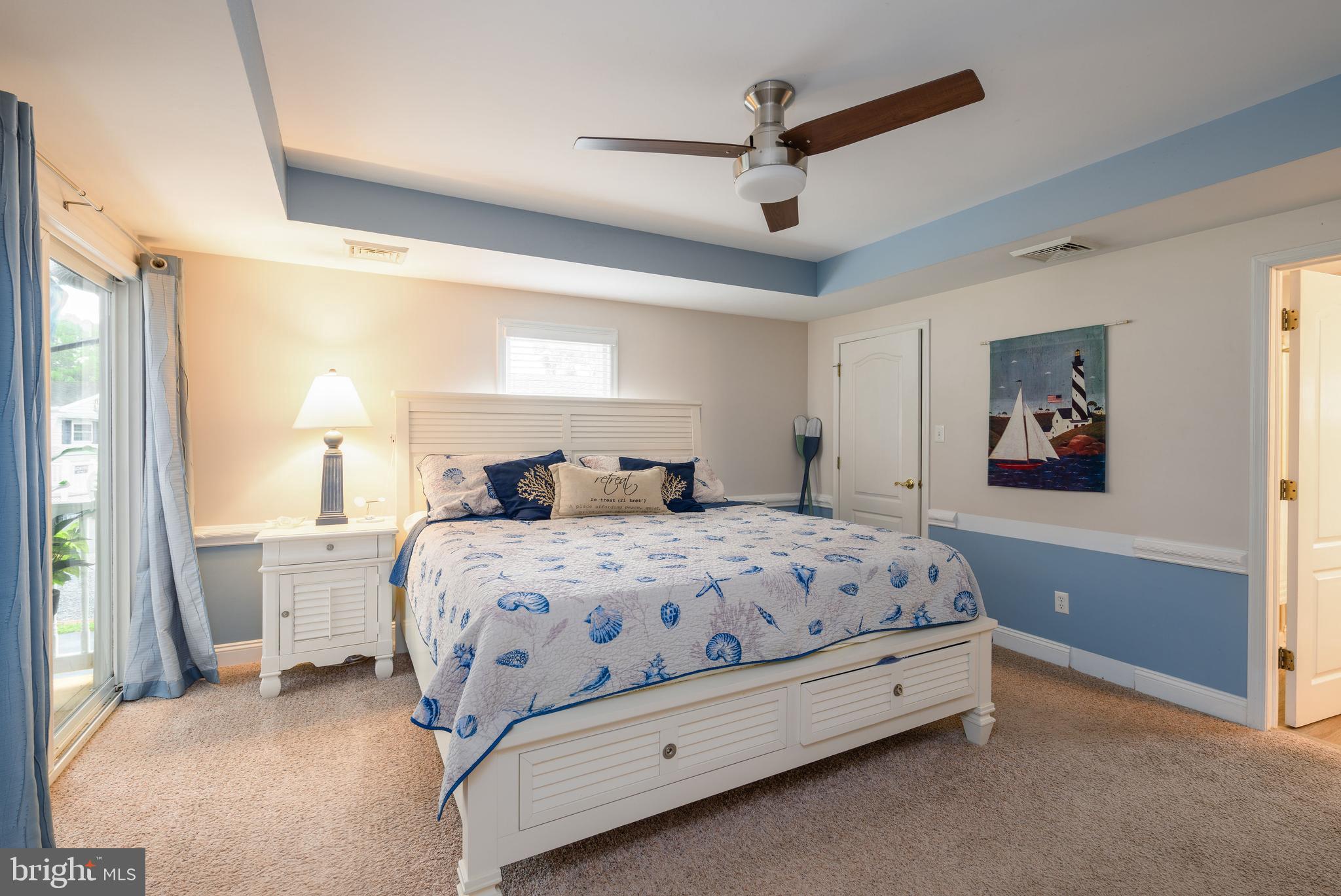 34386 Mallard Road, Unit 482 Long Neck, DE 19966 - Photo 20 of 41 a bedroom with a bed and a large mirror