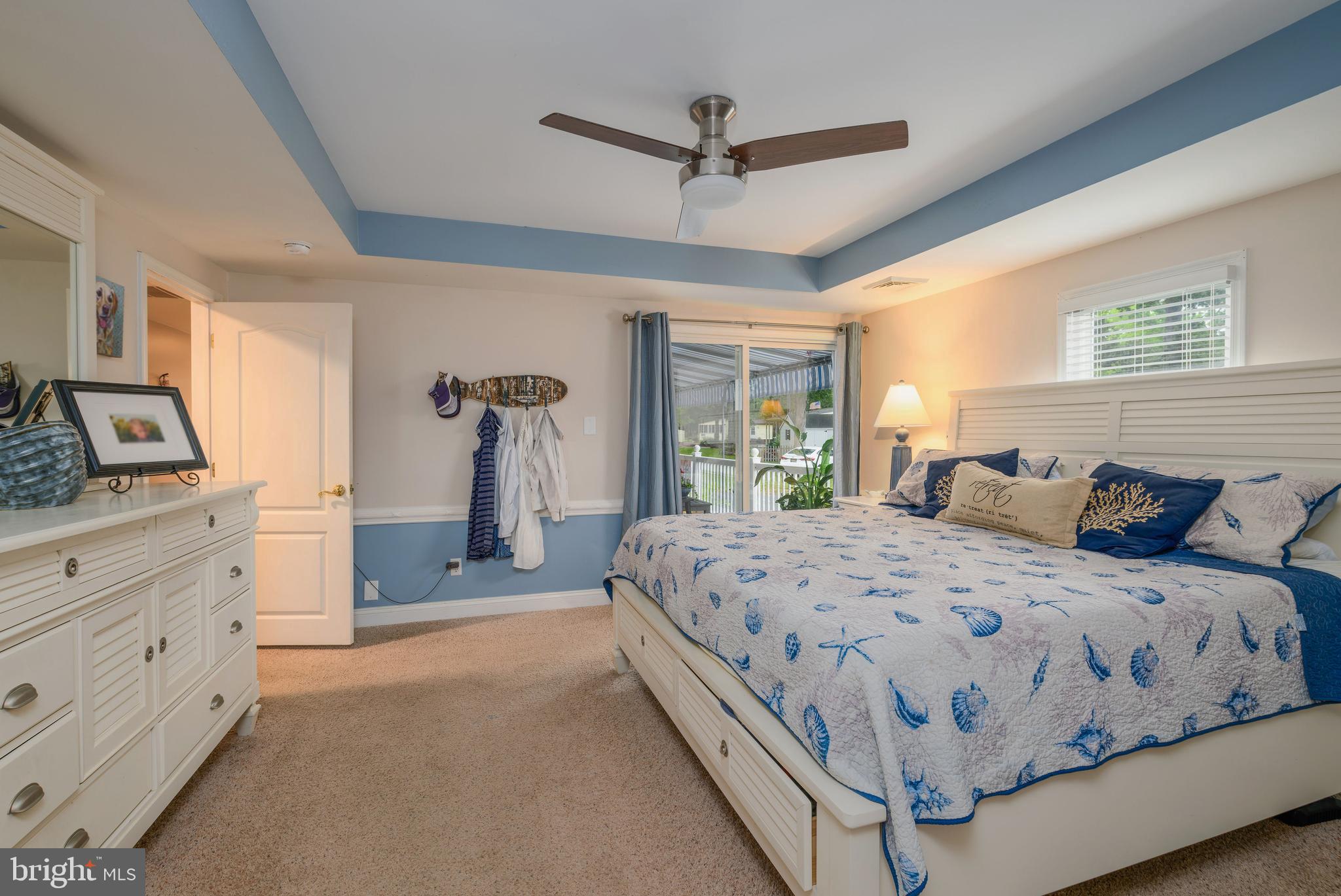 34386 Mallard Road, Unit 482 Long Neck, DE 19966 - Photo 21 of 41 a bedroom with a bed and a dresser