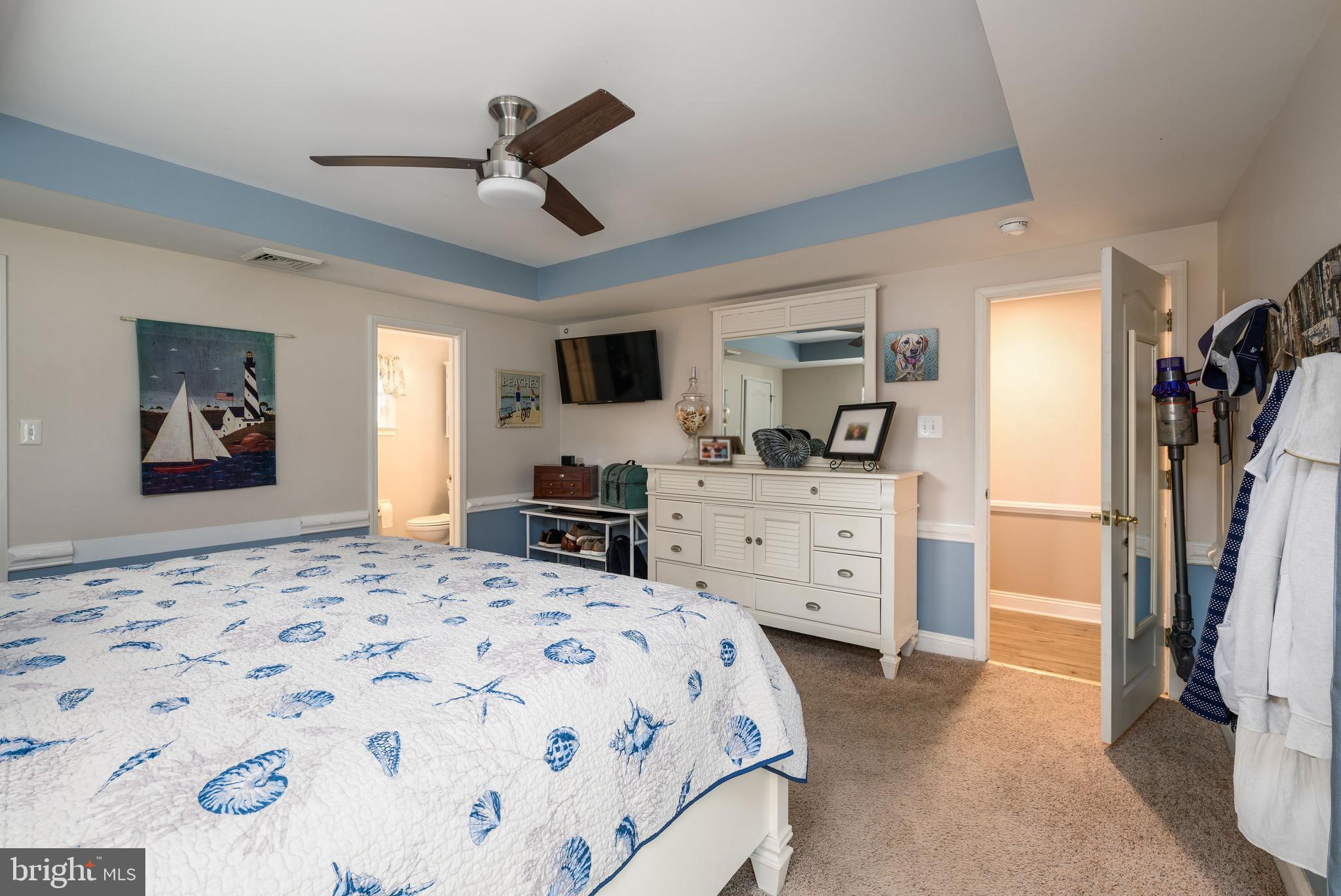 34386 Mallard Road, Unit 482 Long Neck, DE 19966 - Photo 22 of 41 a bedroom with a bed and ceiling fan