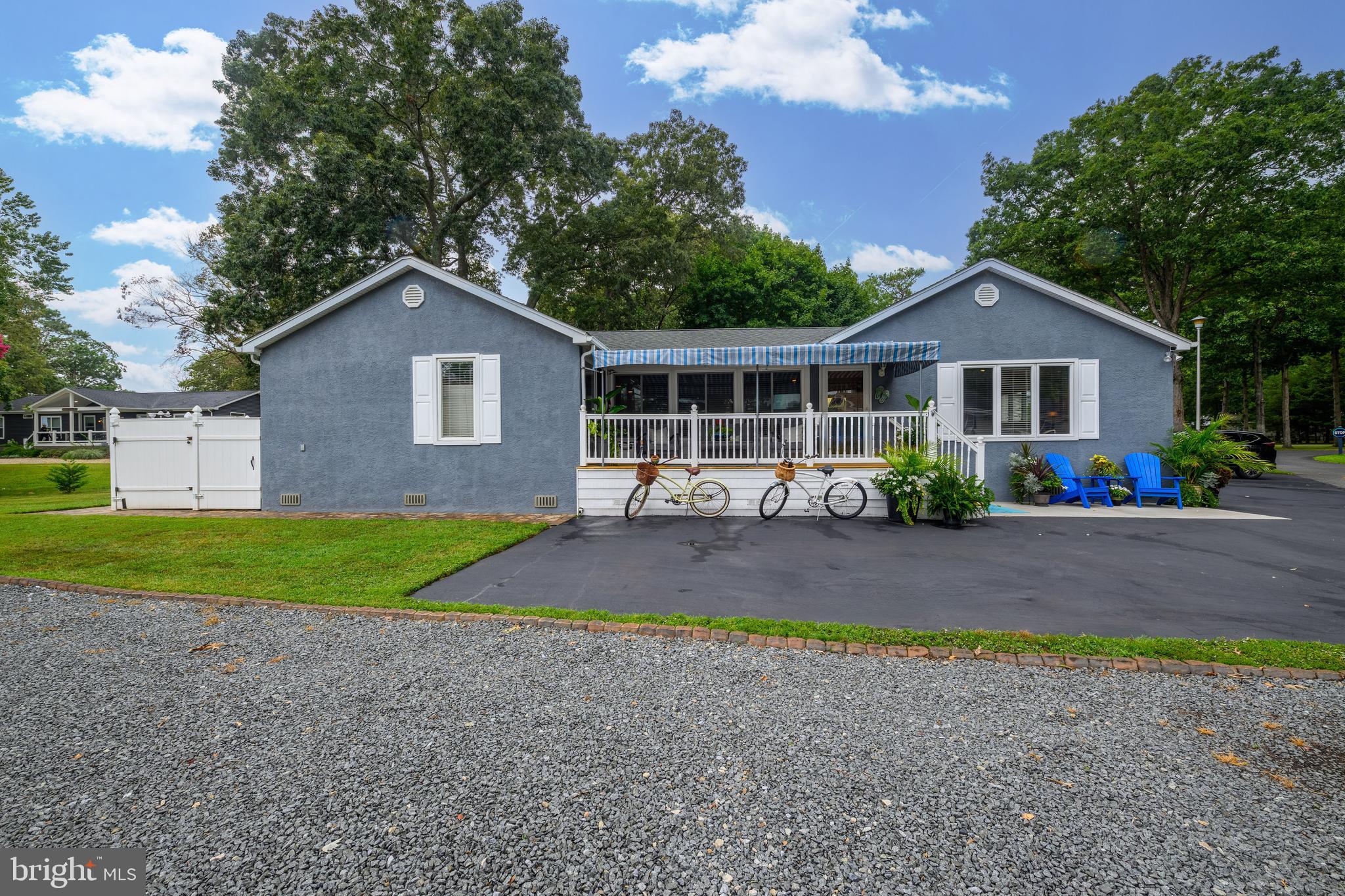 34386 Mallard Road, Unit 482 Long Neck, DE 19966 - Photo 3 of 41 a front view of a house with a yard and garage
