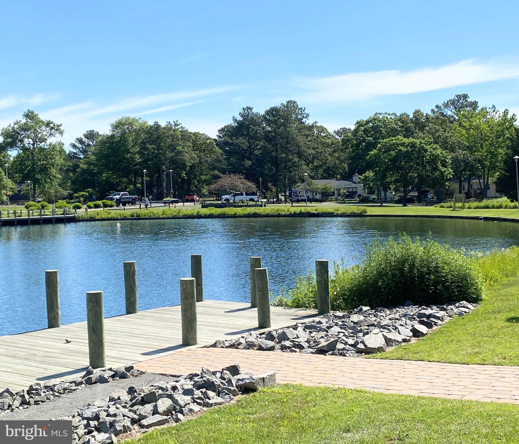 34386 Mallard Road, Unit 482 Long Neck, DE 19966 - Photo 33 of 41 a view of a lake with a house in the background
