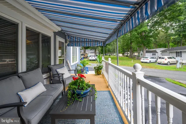 a view of a patio with chairs and potted plants
