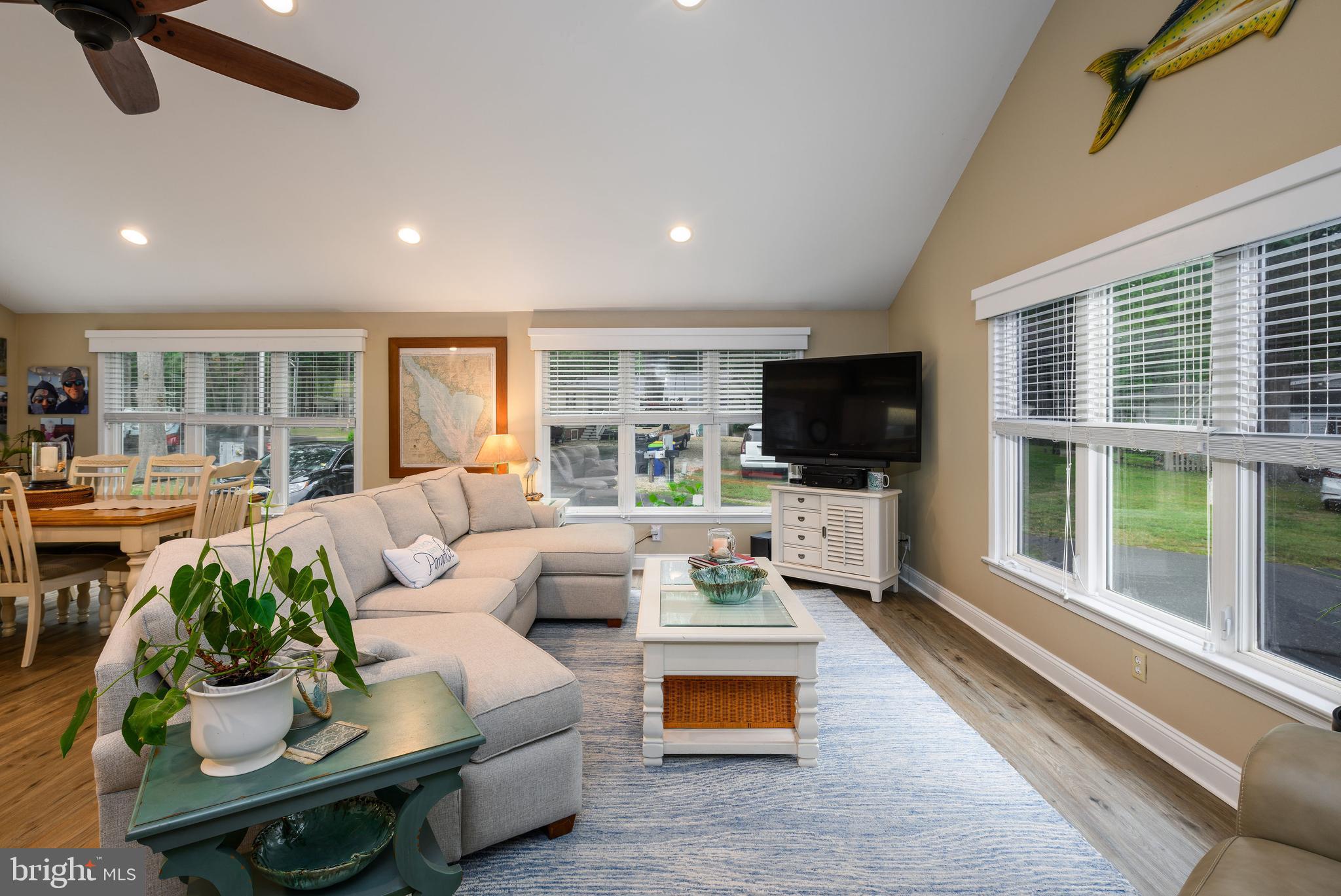 34386 Mallard Road, Unit 482 Long Neck, DE 19966 - Photo 9 of 41 a living room with furniture and a flat screen tv