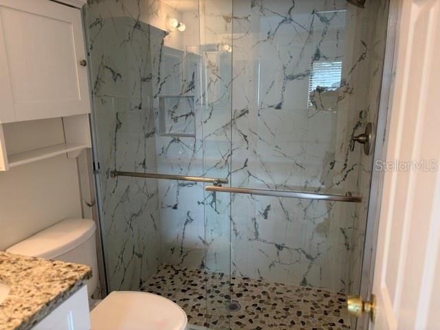 25225 Rampart Boulevard, Unit 1702 Punta Gorda, FL 33983 - Photo 13 of 19 a bathroom with a toilet and shower