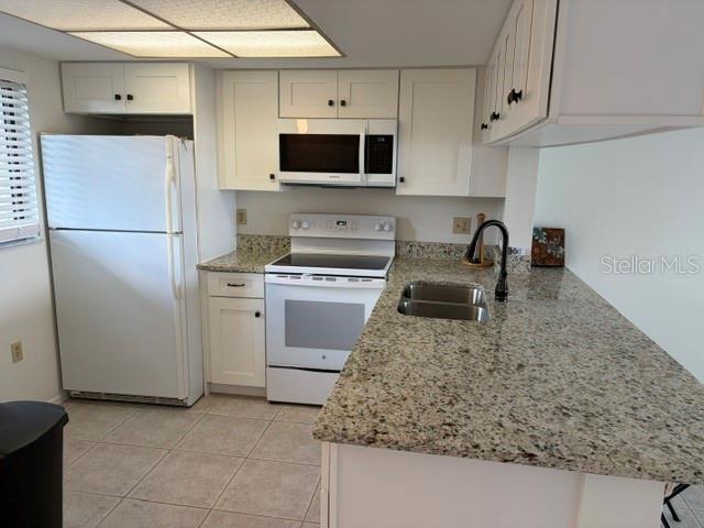 25225 Rampart Boulevard, Unit 1702 Punta Gorda, FL 33983 - Photo 4 of 19 a kitchen with a sink a stove and refrigerator