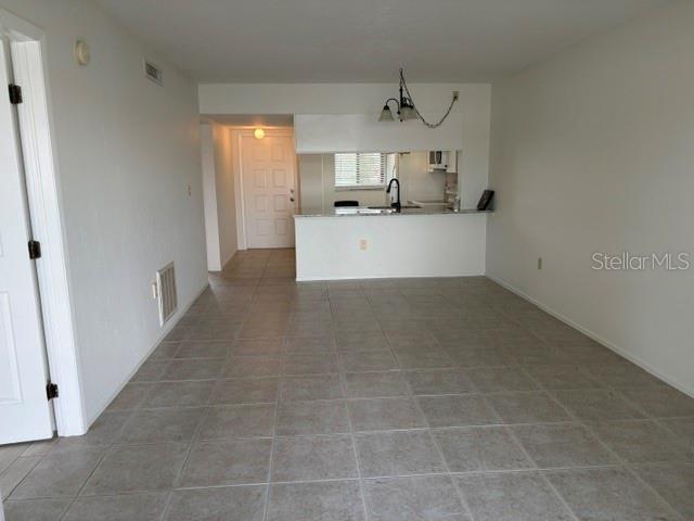 25225 Rampart Boulevard, Unit 1702 Punta Gorda, FL 33983 - Photo 9 of 19 a view of a kitchen with an empty space and a window