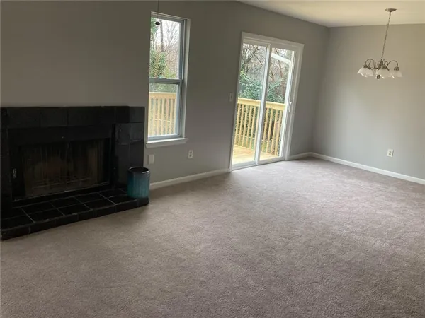 a view of empty room with a fireplace