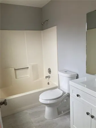 a white toilet sitting next to a bathroom sink