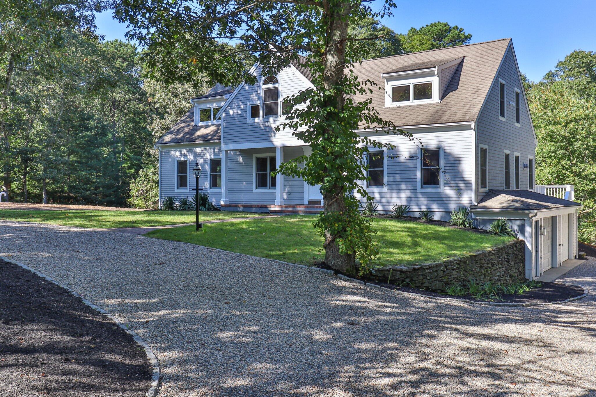 150 Lewis Pond Road Cotuit, MA 02635 - Photo 1 of 50 a view of a big house with a big yard and large trees