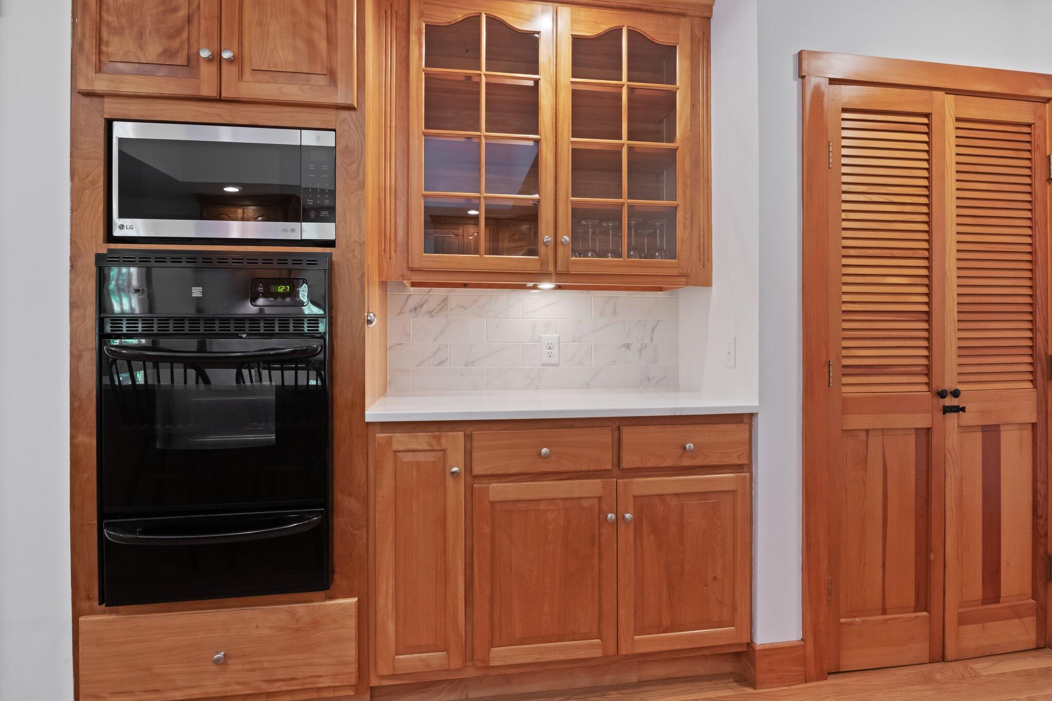 150 Lewis Pond Road Cotuit, MA 02635 - Photo 15 of 50 a kitchen with granite countertop cabinets and refrigerator