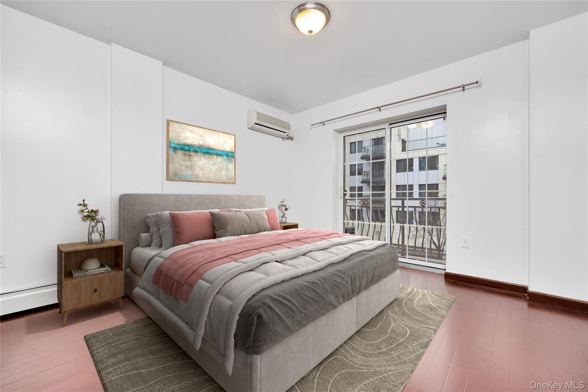 132-36 Pople Avenue, Unit 3A Queens, NY 11355 - Photo 15 of 24 Bedroom with access to exterior, hardwood / wood-style flooring, a wall mounted air conditioner, and a baseboard heating unit