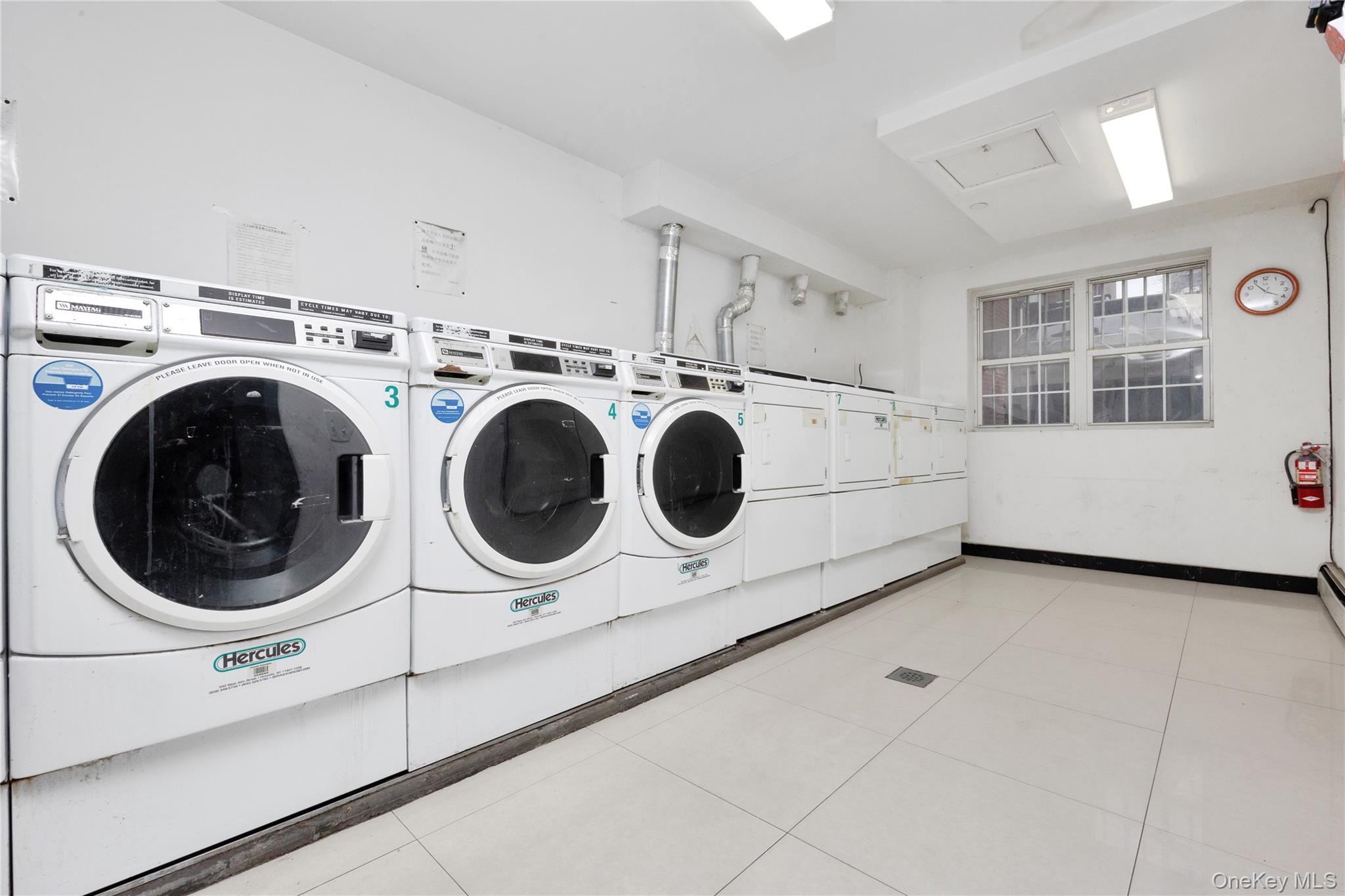 132-36 Pople Avenue, Unit 3A Queens, NY 11355 - Photo 22 of 24 Communal laundry room featuring washing machine and dryer
