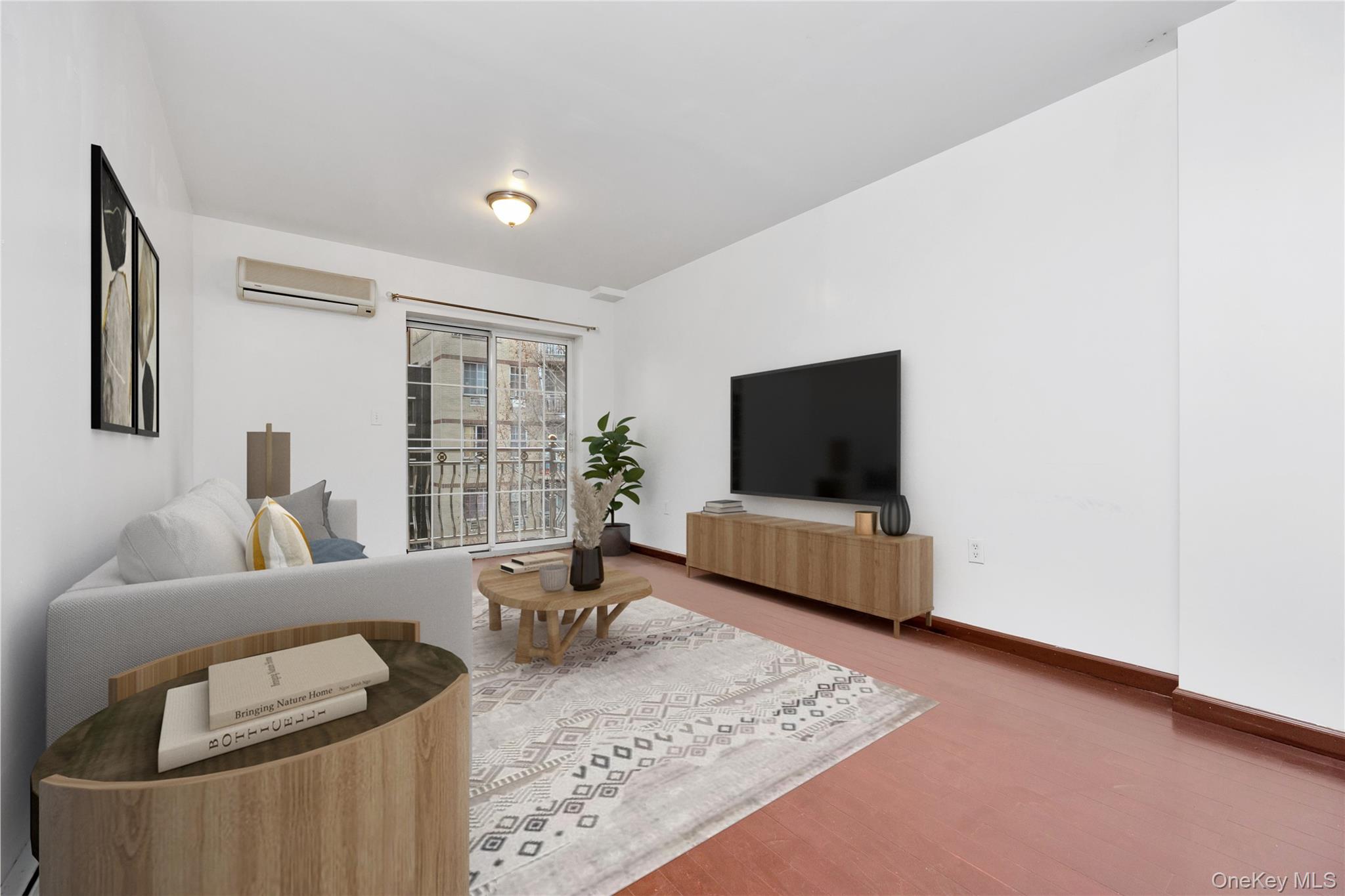 132-36 Pople Avenue, Unit 3A Queens, NY 11355 - Photo 7 of 24 Living room with a wall mounted AC and wood finished floors