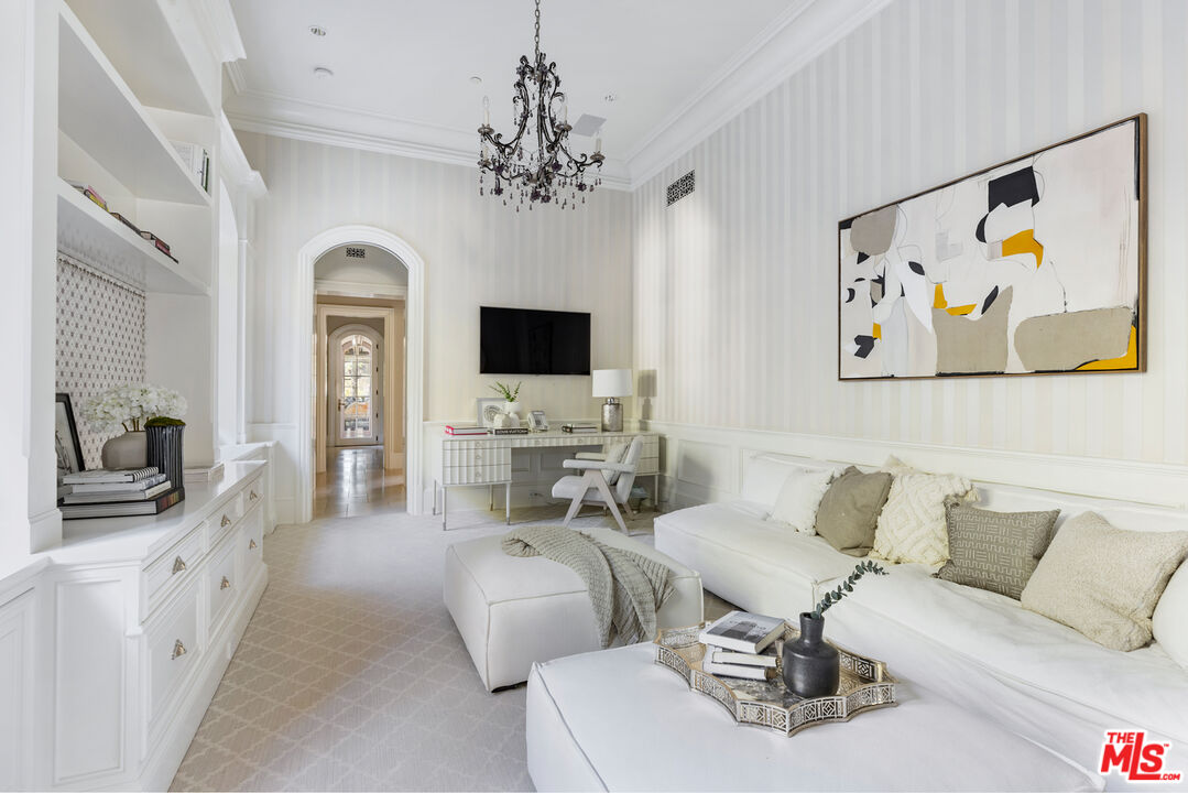 71 Beverly Park Beverly Hills, CA 90210 - Photo 18 of 45 a living room with furniture a fireplace and a flat screen tv