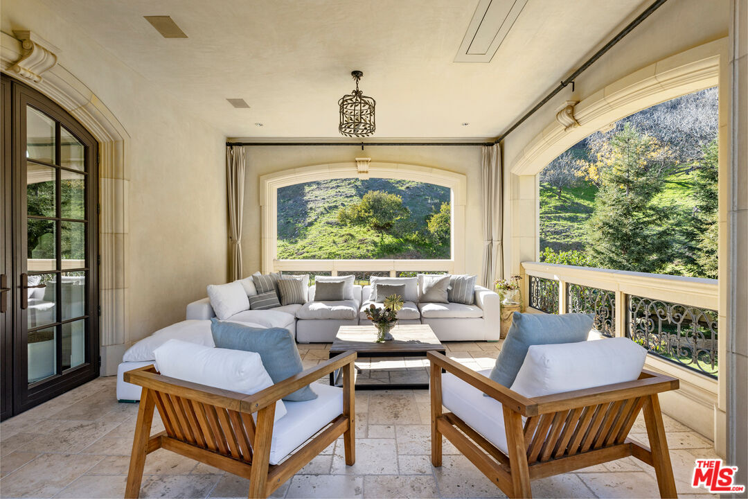 71 Beverly Park Beverly Hills, CA 90210 - Photo 26 of 45 a living room with furniture a window and a chandelier