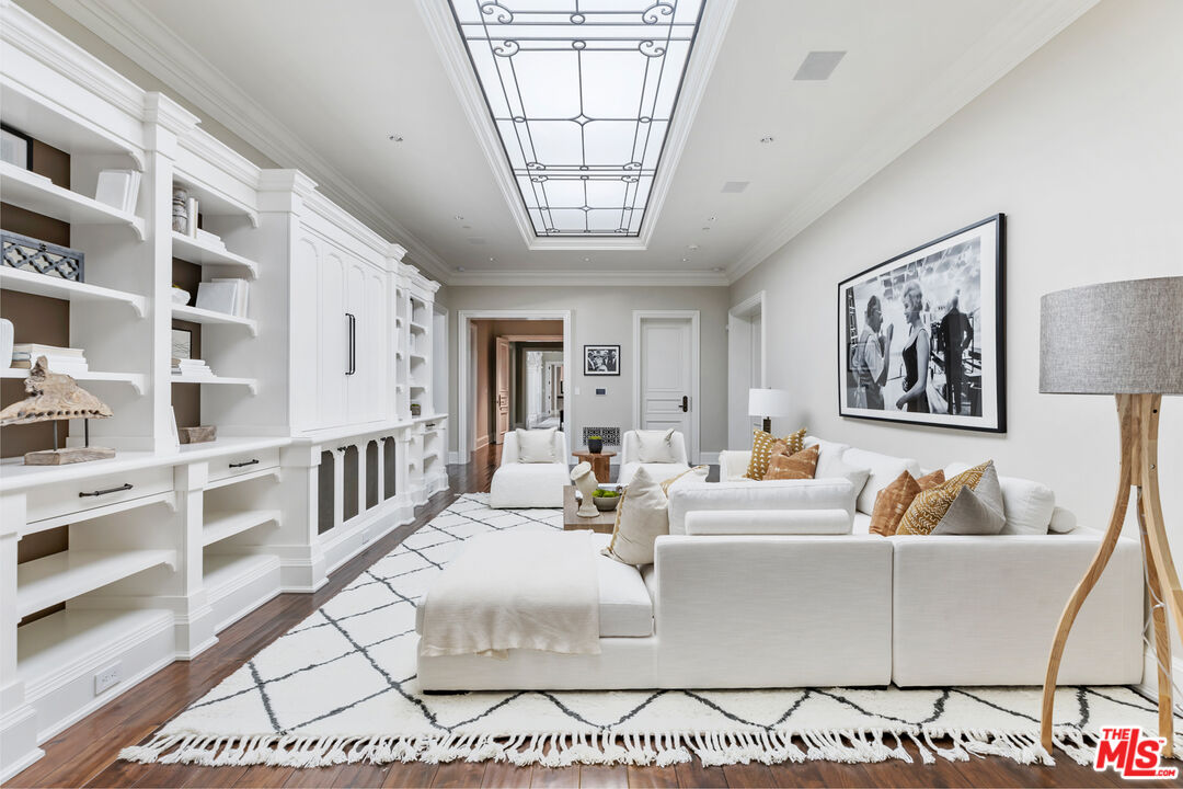 71 Beverly Park Beverly Hills, CA 90210 - Photo 27 of 45 a living room with furniture a flat screen tv and a table