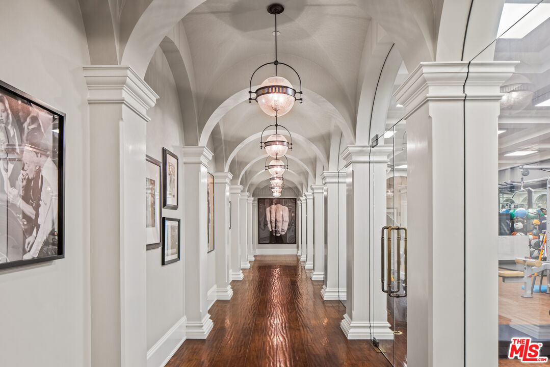 71 Beverly Park Beverly Hills, CA 90210 - Photo 29 of 45 a view of a hallway with wooden floor and staircase
