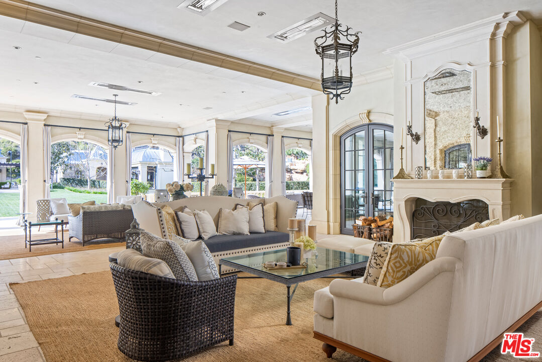 71 Beverly Park Beverly Hills, CA 90210 - Photo 33 of 45 a living room with furniture a dining table and a chandelier