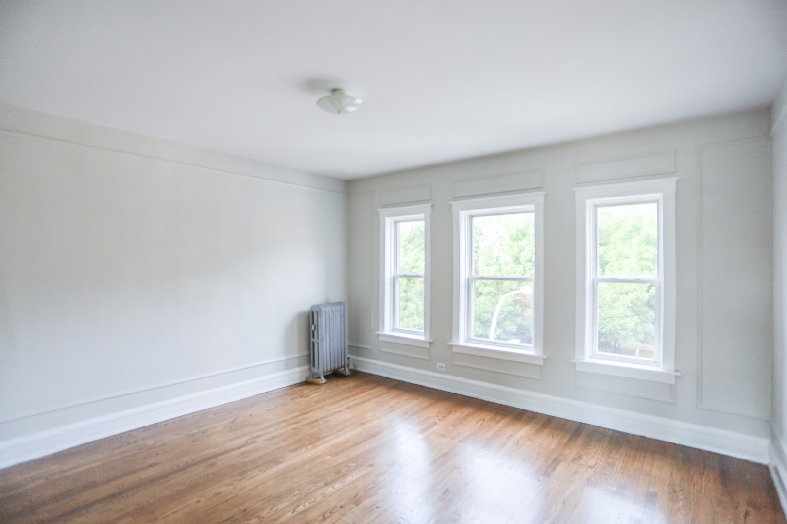 2659 North Spaulding Avenue, Unit 123 Chicago, IL 60647 - Photo 3 of 7 an empty room with wooden floor and windows
