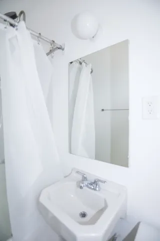 a white bath tub sitting next to a white sink