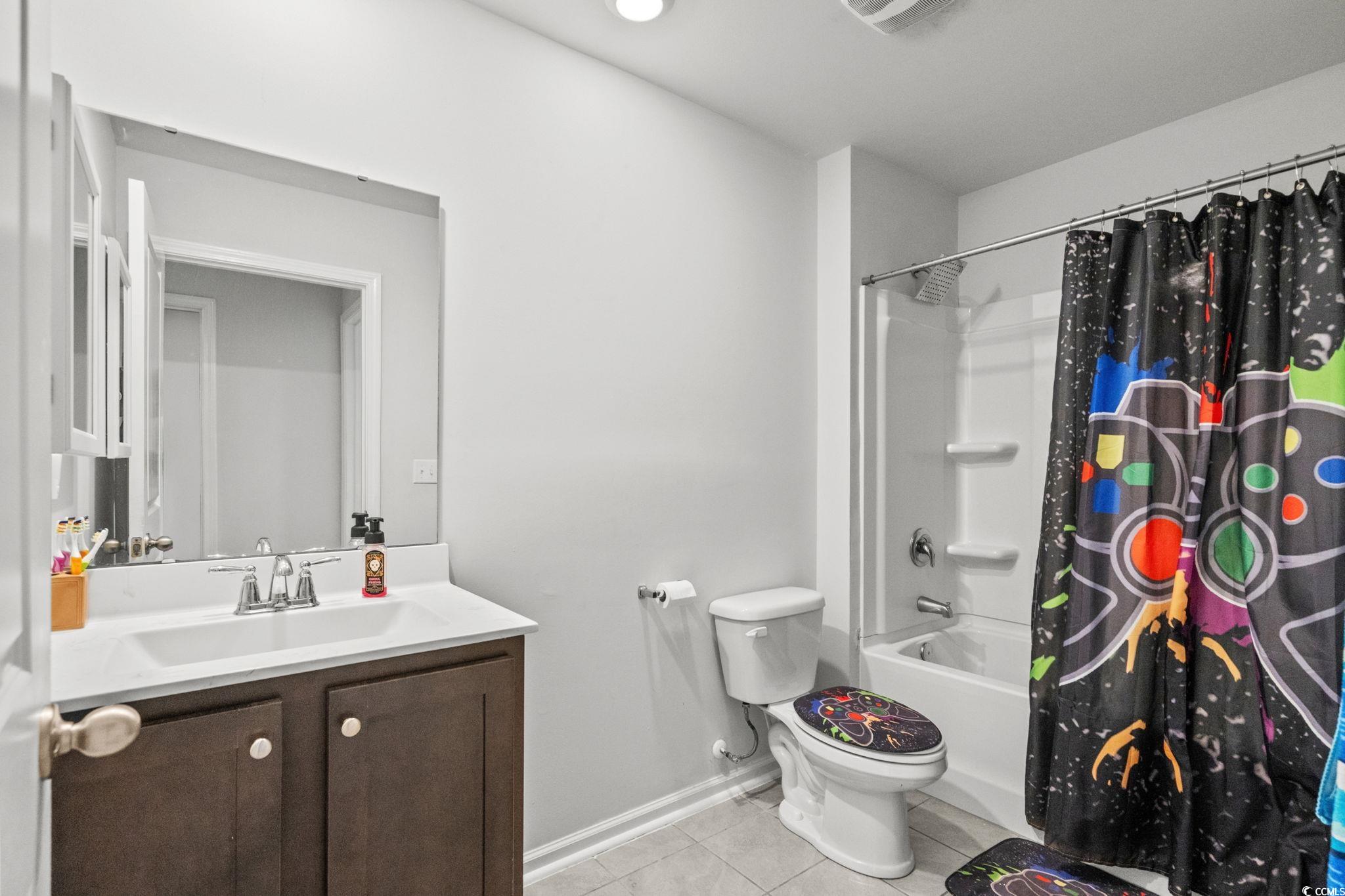 899 Snowberry Drive Longs, SC 29568 - Photo 17 of 27 Bathroom with shower / bath combination with curtain, vanity, and light tile patterned floors