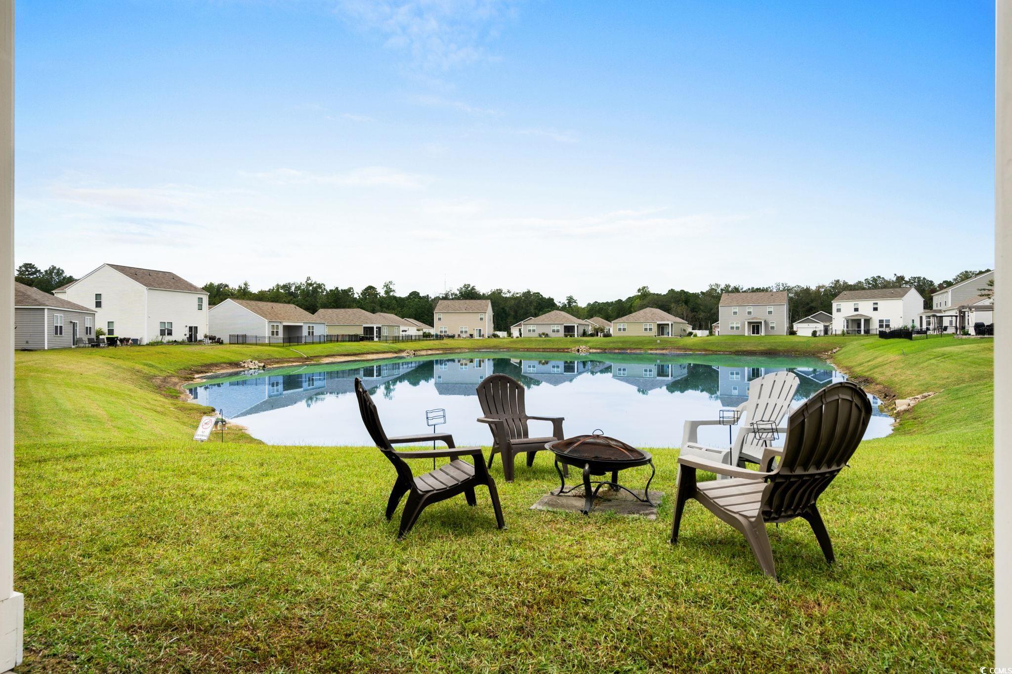 899 Snowberry Drive Longs, SC 29568 - Photo 21 of 27 View of grassy yard featuring a residential view, a patio, and an outdoor fire pit