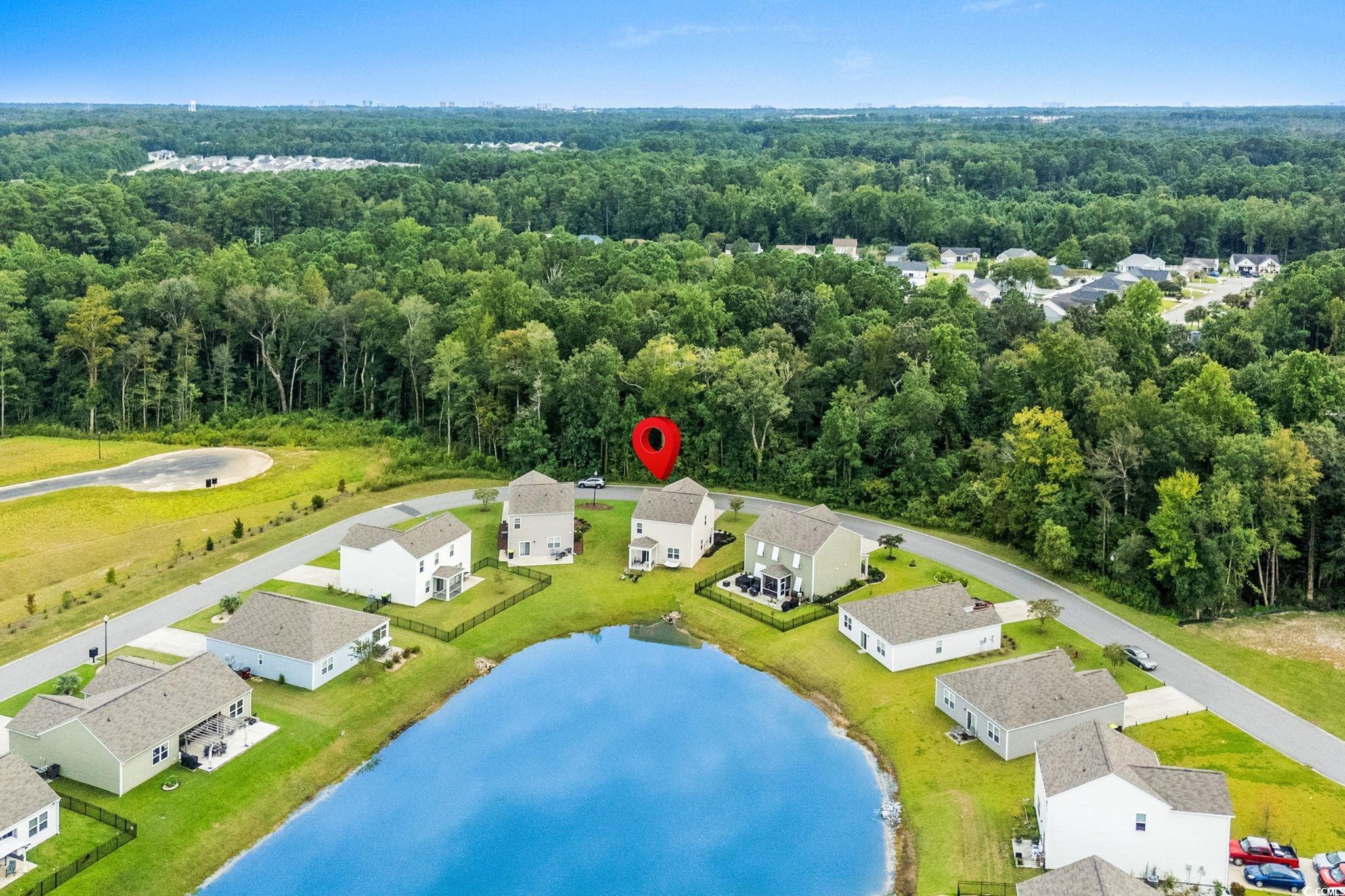 899 Snowberry Drive Longs, SC 29568 - Photo 22 of 27 Aerial perspective of suburban area with a forest and a nearby body of water