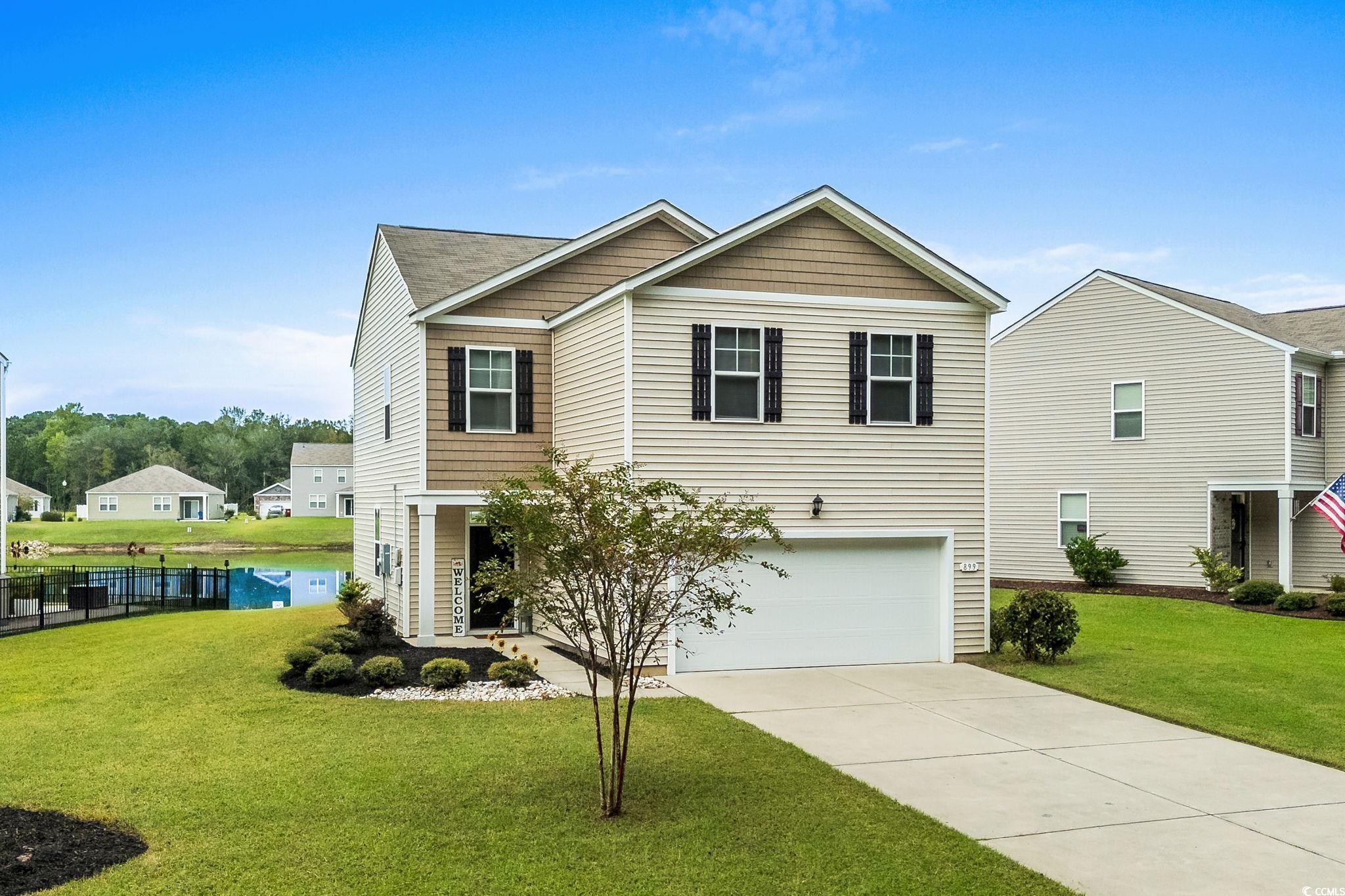899 Snowberry Drive Longs, SC 29568 - Photo 24 of 27 View of front facade featuring concrete driveway and a garage