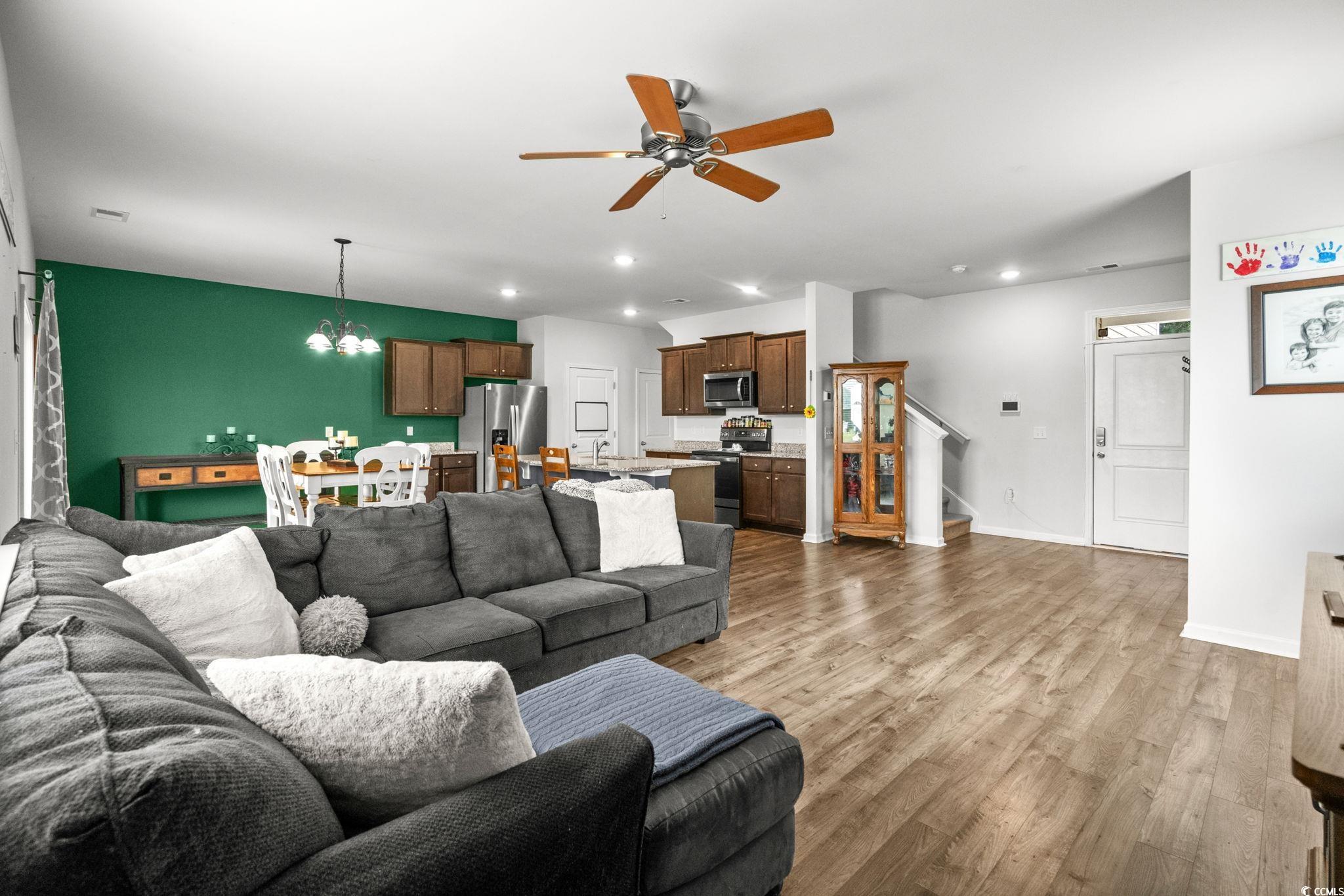 899 Snowberry Drive Longs, SC 29568 - Photo 6 of 27 Living room featuring light wood-type flooring, a ceiling fan, a chandelier, recessed lighting, and stairs