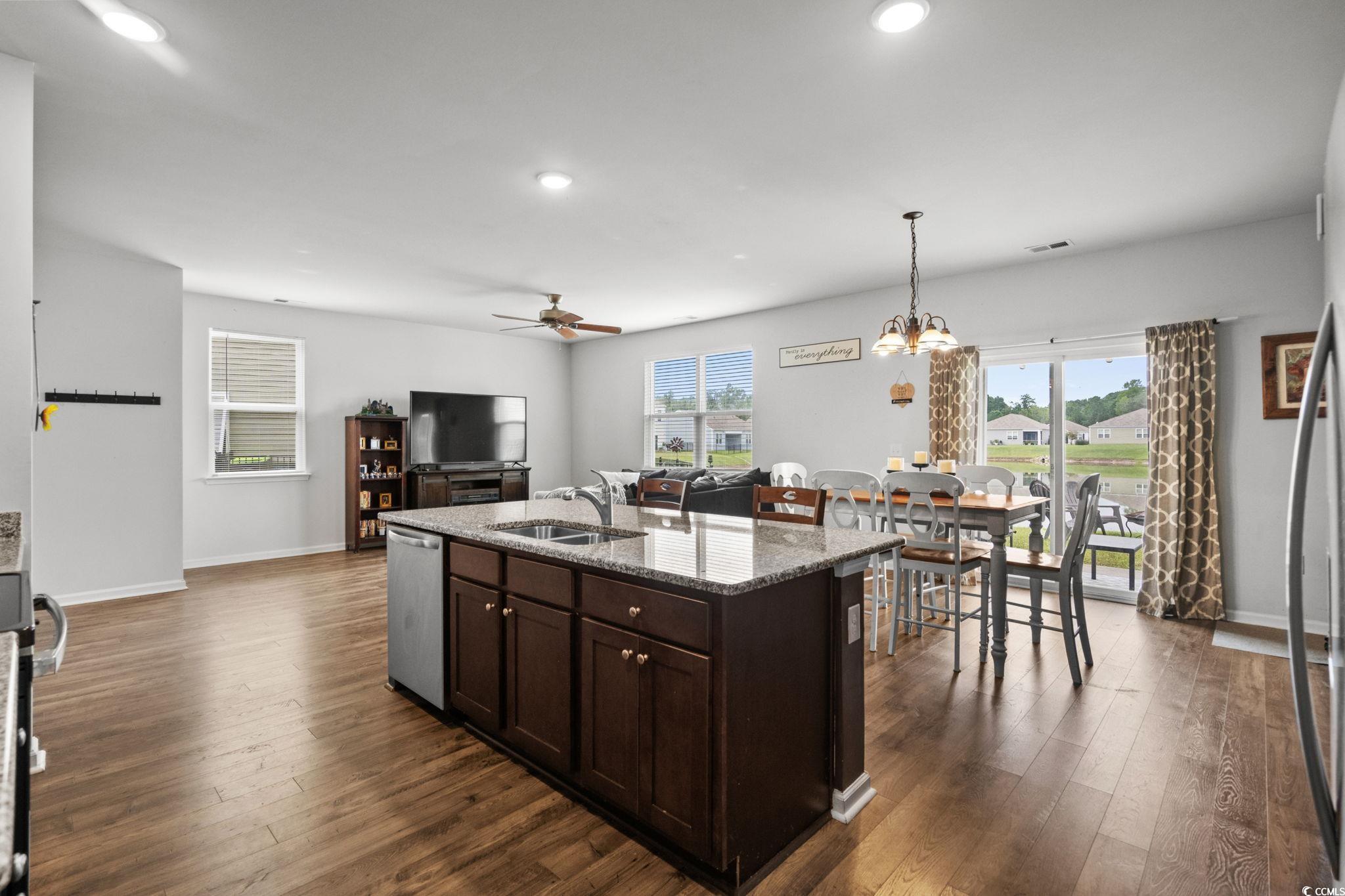 899 Snowberry Drive Longs, SC 29568 - Photo 10 of 27 Kitchen with dark brown cabinets, light stone countertops, a ceiling fan, dark wood-style flooring, and recessed lighting