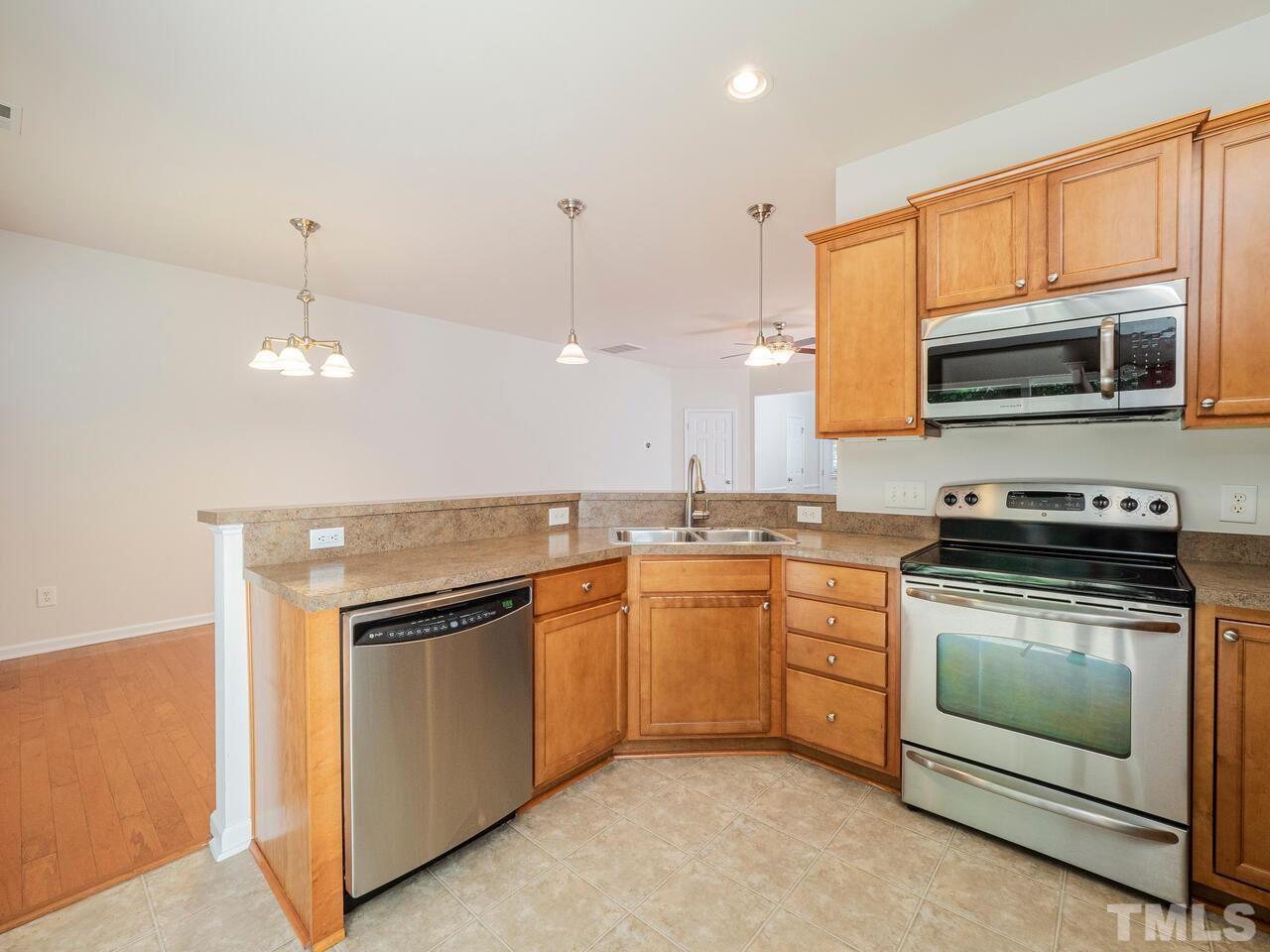 7004 Racine Way Raleigh, NC 27690 - Photo 14 of 27 a kitchen with a stove microwave and sink