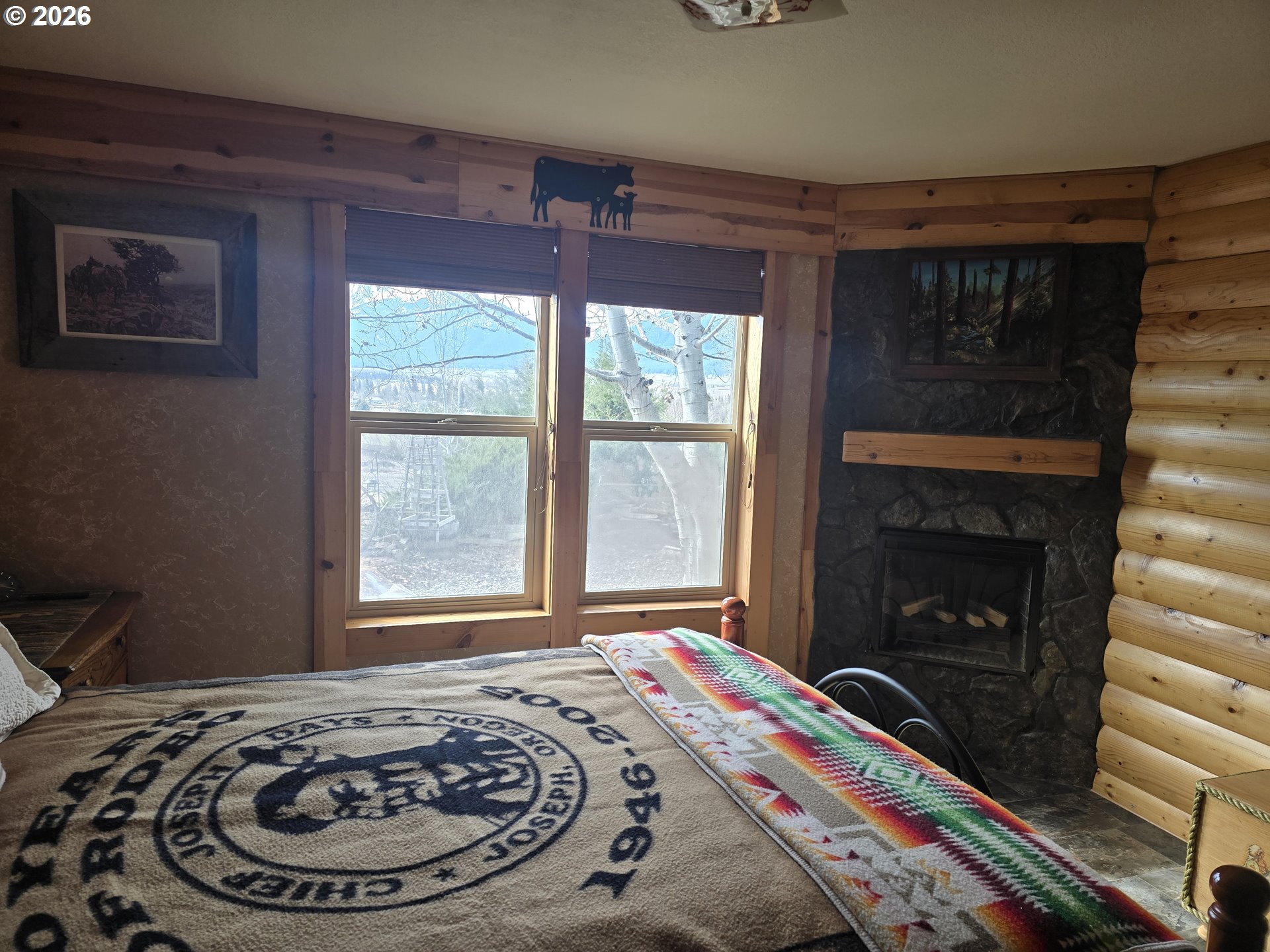 704 Residence Street Enterprise, OR 97828 - Photo 21 of 26 a bed sitting in a bedroom next to a window