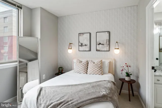 a bedroom with a bed and cabinets