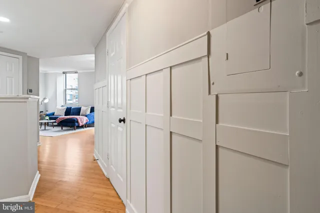 a view of a hallway with stainless steel appliances granite countertop a refrigerator and a stove top oven