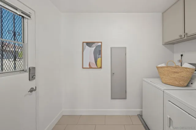 a view of kitchen and empty room with wooden floor