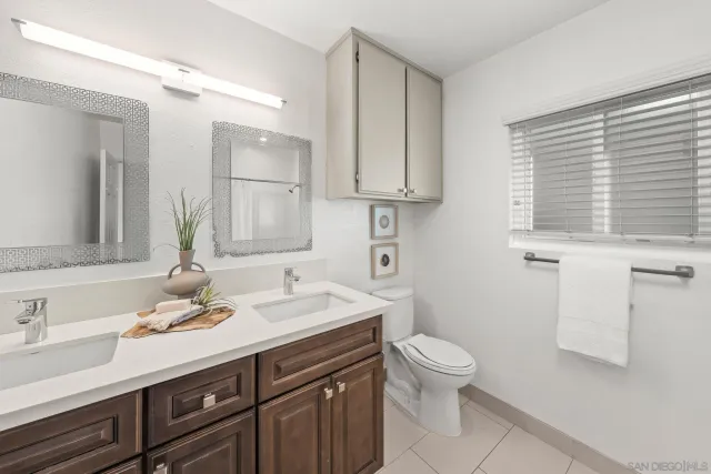 a bathroom with a toilet a sink and a shower