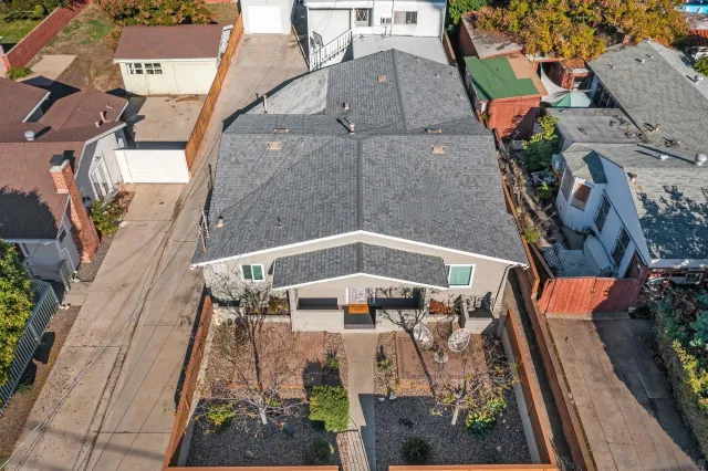 an aerial view of a house with a yard