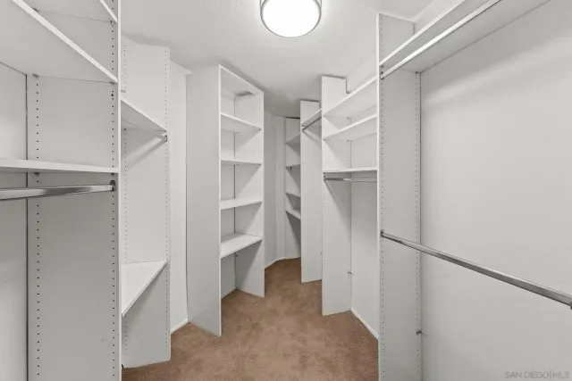 an empty room with a ceiling fan and a window