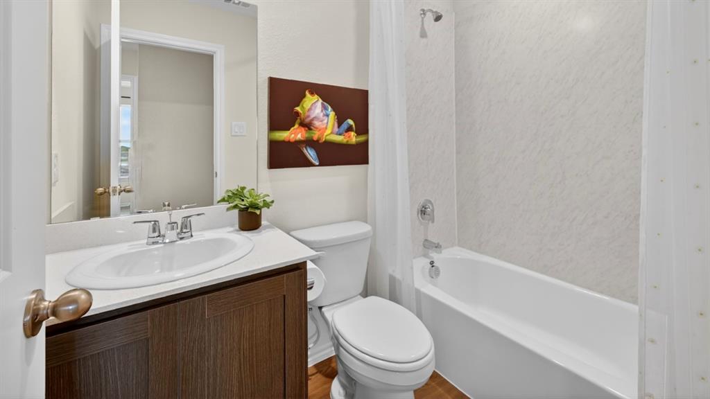 3514 Spring Time Street Terrell, TX 75126 - Photo 22 of 26 Bathroom featuring a white vanity with an undermount sink, brushed nickel faucet, and a wall-mounted mirror
