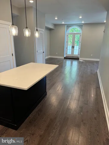 a large kitchen with a lot of counter space and a refrigerator