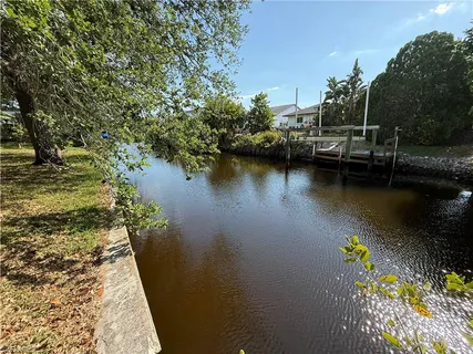 an aerial view of a house with a yard and lake view