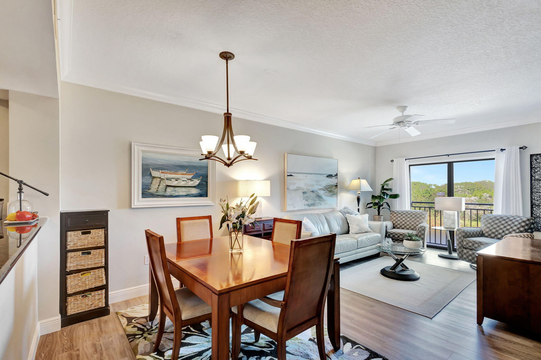 4903 Midtown Lane, Unit 3313 Palm Beach Gardens, FL 33418 - Photo 7 of 81 a view of a dining room and livingroom with furniture wooden floor a rug a painting and a chandelier