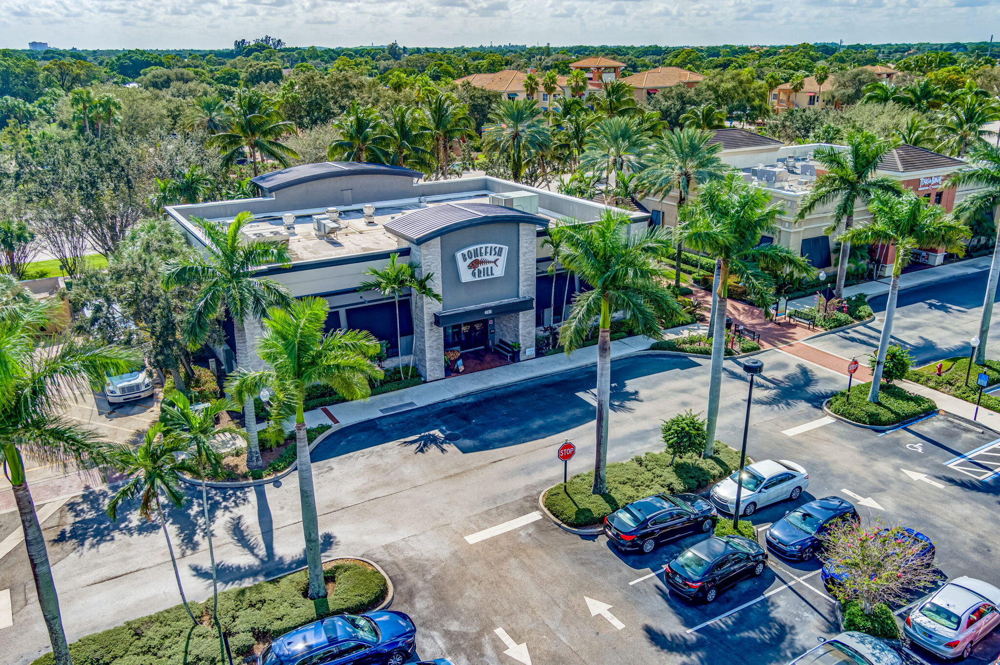 4903 Midtown Lane, Unit 3313 Palm Beach Gardens, FL 33418 - Photo 74 of 81 a view of a chairs and table in a garden