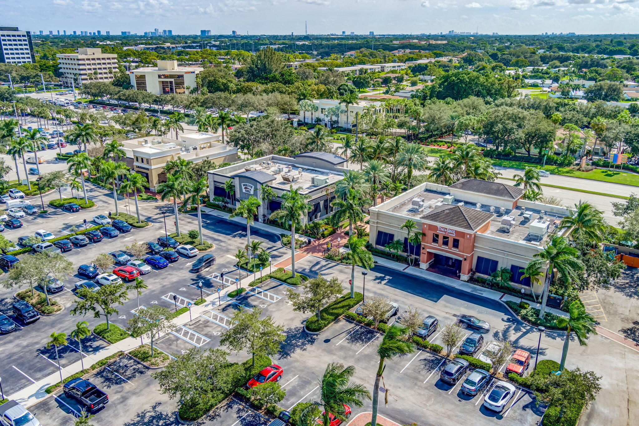 4903 Midtown Lane, Unit 3313 Palm Beach Gardens, FL 33418 - Photo 76 of 81 an aerial view of a city with lots of residential buildings ocean and mountain view in back